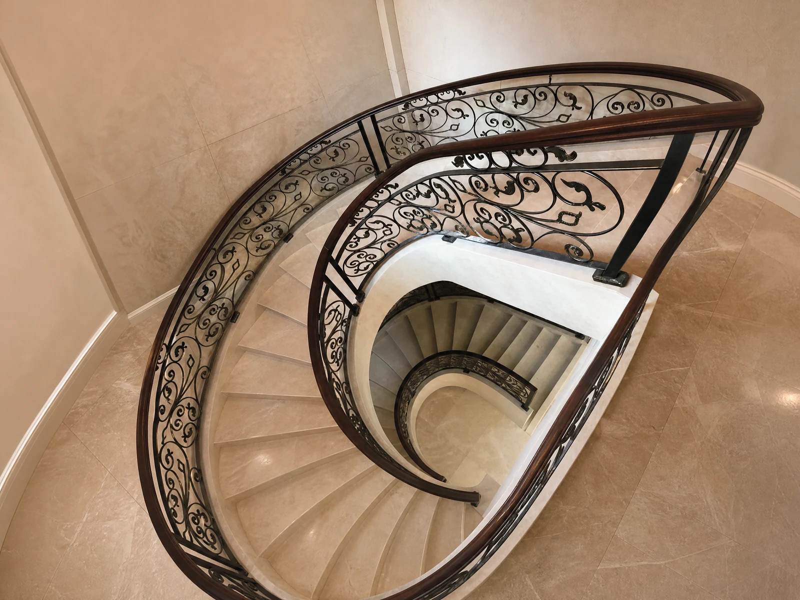 European Indoor Wrought Iron Curved Stair Railing with Black Ornate Panels and Wood Handrail European Indoor Wrought Iron Curved Stair Railing with Black Ornate Panels and Wood Handrail
