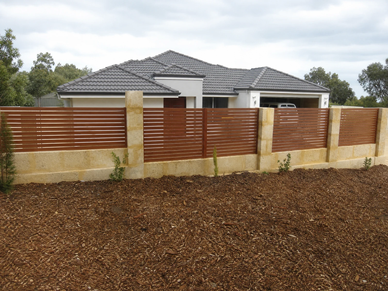Modern Horizontal Slat Fence with Brown Red Panels and Stone Pillars Modern Horizontal Slat Fence with Brown Red Panels and Stone Pillars